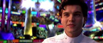 Movie still from “Speed Racer” (2008), directed by Lilly Wachowski – A man in a white shirt is looking at the camera; Close Up shot, Over the shoulder angle