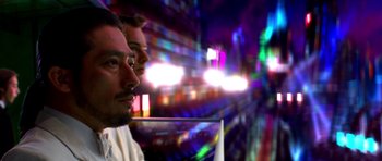 Movie still from “Speed Racer” (2008), directed by Lilly Wachowski – Two men are standing next to each other in the dark; Extreme Close Up shot, Low angle