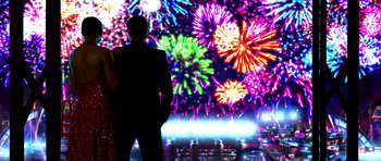 Movie still from “Speed Racer” (2008), directed by Lilly Wachowski – A man and a woman standing in front of a fireworks display; Extreme Wide shot, Low angle