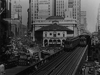 Movie still from “Speedy” (1928), directed by Ted Wilde – An old black and white photo of a train on the tracks; Extreme Wide shot, High angle