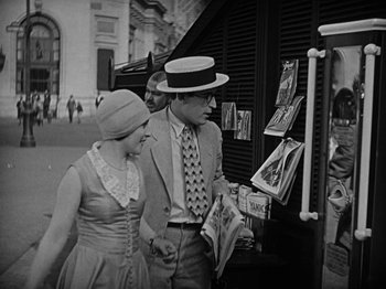 Movie still from “Speedy” (1928), directed by Ted Wilde – A man and a woman are walking down the street; Medium shot, Low angle
