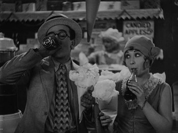 Movie still from “Speedy” (1928), directed by Ted Wilde – A man and a woman taking a picture of themselves; Medium shot, High angle