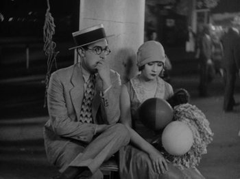 Movie still from “Speedy” (1928), directed by Ted Wilde – A man and a woman sitting next to each other on a bench; Medium shot, High angle