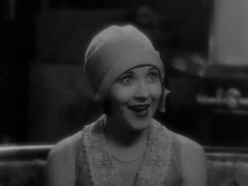 Movie still from “Speedy” (1928), directed by Ted Wilde – An old photo of a woman wearing a hat; Close Up shot, High angle