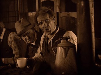 Movie still from “Speedy” (1928), directed by Ted Wilde – Two men sitting at a table drinking coffee; Medium shot, High angle