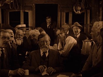 Movie still from “Speedy” (1928), directed by Ted Wilde – A group of men sitting at a table in front of a window; Wide shot, High angle
