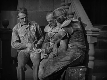 Movie still from “Speedy” (1928), directed by Ted Wilde – A group of men sitting next to each other on a bench; Medium shot, High angle