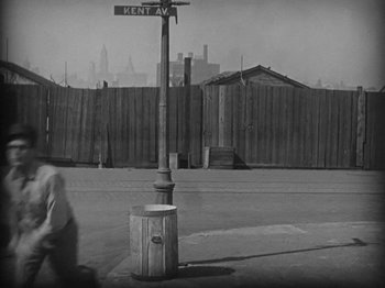 Movie still from “Speedy” (1928), directed by Ted Wilde – A black and white photo of a street sign; Wide shot, High angle