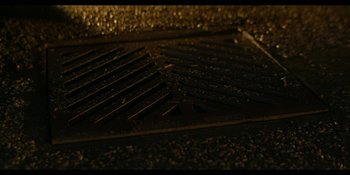 Movie still from “Spin” (2021), directed by Manjari Makijany – A metal grate on the ground; Extreme Close Up shot, Overhead angle