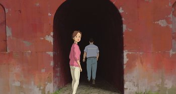 Movie still from “Spirited Away” (2001), directed by Hayao Miyazaki – A woman and a man are standing in a tunnel; Wide shot, Over the shoulder angle
