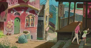 Movie still from “Spirited Away” (2001), directed by Hayao Miyazaki – An asian city street scene with buildings and stairs leading up to a building; Extreme Wide shot, High angle