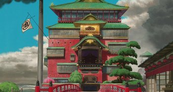 Movie still from “Spirited Away” (2001), directed by Hayao Miyazaki – An illustration of an asian style building with a red fence; Extreme Wide shot, Low angle