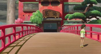 Movie still from “Spirited Away” (2001), directed by Hayao Miyazaki – An asian style building with a bridge going over it; Extreme Wide shot, Low angle