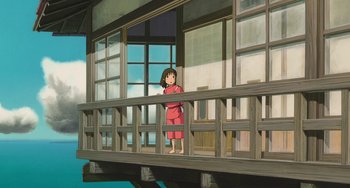 Movie still from “Spirited Away” (2001), directed by Hayao Miyazaki – A girl standing on a balcony looking out the window; Extreme Wide shot, Low angle
