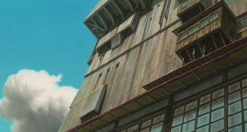 Movie still from “Spirited Away” (2001), directed by Hayao Miyazaki – A building with a sky in the background; Extreme Wide shot, Low angle