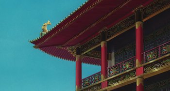 Movie still from “Spirited Away” (2001), directed by Hayao Miyazaki – A red and gold building with a golden roof; Extreme Wide shot, Low angle