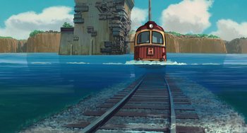 Movie still from “Spirited Away” (2001), directed by Hayao Miyazaki – A train traveling down train tracks next to a body of water; Extreme Wide shot, High angle