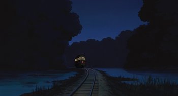 Movie still from “Spirited Away” (2001), directed by Hayao Miyazaki – A train traveling down the tracks at night time; Extreme Wide shot, Low angle