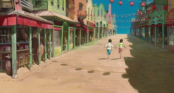 Movie still from “Spirited Away” (2001), directed by Hayao Miyazaki – Two children running down a street in a city; Extreme Wide shot, High angle