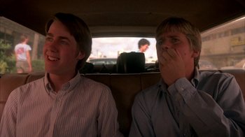 Movie still from “Spring Break” (1983), directed by Sean S. Cunningham – Two men sitting in the back seat of a car; Close Up shot, Over the shoulder angle