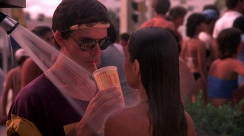Movie still from “Spring Break” (1983), directed by Sean S. Cunningham – A man and a woman are drinking a cup of coffee; Medium shot, Over the shoulder angle