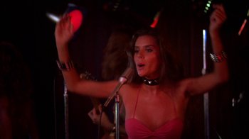 Movie still from “Spring Break” (1983), directed by Sean S. Cunningham – A woman in a pink top singing into a microphone; Close Up shot, Low angle