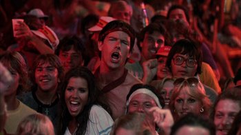 Movie still from “Spring Break” (1983), directed by Sean S. Cunningham – A group of people that are standing in a crowd; Close Up shot, Low angle