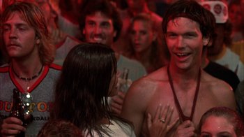 Movie still from “Spring Break” (1983), directed by Sean S. Cunningham – A group of people in a room talking to each other; Close Up shot, Over the shoulder angle