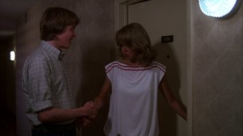 Movie still from “Spring Break” (1983), directed by Sean S. Cunningham – A man and a woman standing next to each other in front of a door; Medium shot, Over the shoulder angle
