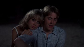 Movie still from “Spring Break” (1983), directed by Sean S. Cunningham – A man and a woman sitting next to each other; Close Up shot, Over the shoulder angle