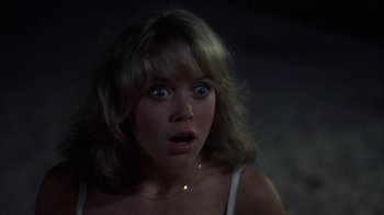 Movie still from “Spring Break” (1983), directed by Sean S. Cunningham – A person with a surprised look on their face; Close Up shot, Over the shoulder angle