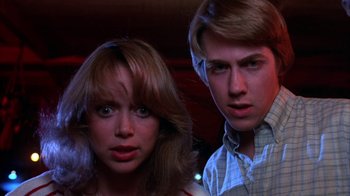 Movie still from “Spring Break” (1983), directed by Sean S. Cunningham – A man and a woman standing next to each other; Close Up shot, Low angle