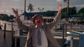 Movie still from “Spring Break” (1983), directed by Sean S. Cunningham – An older man wearing a hat and a suit; Medium shot, Low angle