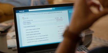 Movie still from “Squared Love All Over Again” (2023), directed by Filip Zylber – A person is looking at a computer screen; Extreme Close Up shot, High angle
