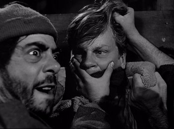 Movie still from “Stalag 17” (1953), directed by Billy Wilder – A man and a boy are posing for a picture; Close Up shot, Over the shoulder angle