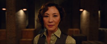 A person with short hair wearing a dress shirt and vest