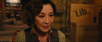 An older asian woman wearing a floral shirt