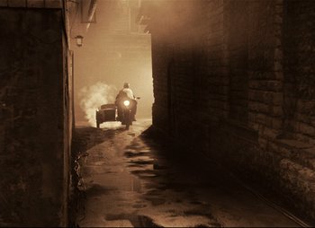 Movie still from “Stalker” (1979), directed by Andrei Tarkovsky – A man riding a train down the middle of a street; Wide shot, High angle