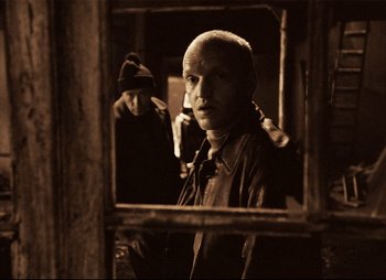 Movie still from “Stalker” (1979), directed by Andrei Tarkovsky – A man standing in front of an open window; Close Up shot, Over the shoulder angle
