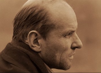 Movie still from “Stalker” (1979), directed by Andrei Tarkovsky – An older man with a bald head looking to his left; Close Up shot, Low angle