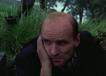 Movie still from “Stalker” (1979), directed by Andrei Tarkovsky – A man with a bald head is leaning on his hand; Close Up shot, High angle