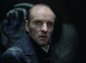 Movie still from “Stalker” (1979), directed by Andrei Tarkovsky – A person wearing a jacket; Close Up shot, Low angle