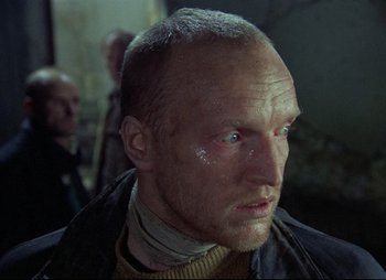 Movie still from “Stalker” (1979), directed by Andrei Tarkovsky – A person wearing a jacket; Close Up shot, Over the shoulder angle