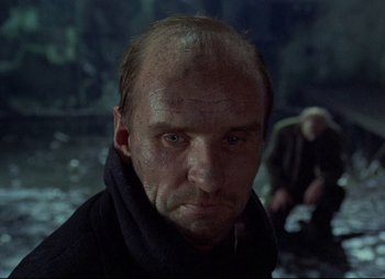 Movie still from “Stalker” (1979), directed by Andrei Tarkovsky – A person wearing a black jacket; Close Up shot, Low angle