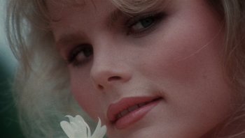 Movie still from “Star 80” (1983), directed by Bob Fosse – The face of a woman with a flower in her mouth; Extreme Close Up shot, Low angle