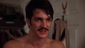 Movie still from “Star 80” (1983), directed by Bob Fosse – A person with a mustache; Close Up shot, Over the shoulder angle