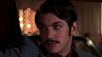 Movie still from “Star 80” (1983), directed by Bob Fosse – A person with a mustache; Close Up shot, Low angle