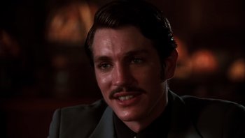 Movie still from “Star 80” (1983), directed by Bob Fosse – A person wearing a suit and a mustache; Close Up shot, Low angle
