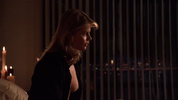 Movie still from “Star 80” (1983), directed by Bob Fosse – A woman in a black shirt is standing in front of a window; Medium shot, Over the shoulder angle