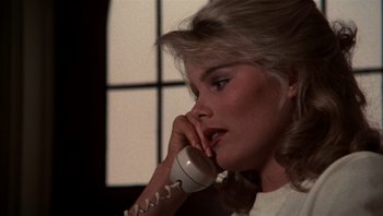 Movie still from “Star 80” (1983), directed by Bob Fosse – A woman talking on a phone while sitting in a chair; Close Up shot, Over the shoulder angle